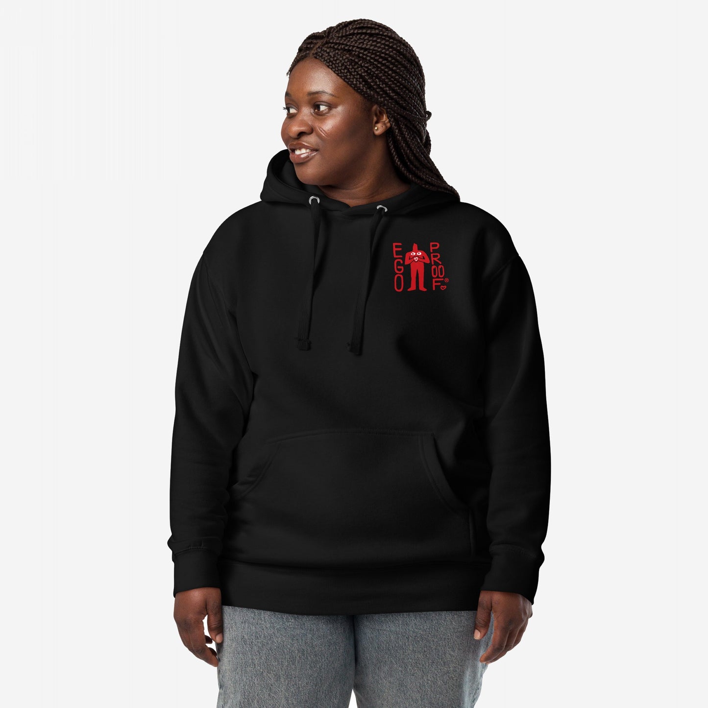 Person in a black 99 Problems Hoodie EU with “EGO PROOF” chest graphic, featuring a bold back print about anxiety. They wear light-wash jeans, embodying casual resilience and mental health awareness.