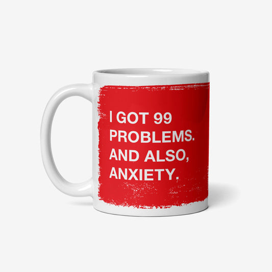 White ceramic 99 Problems Mug with red text stating "I got 99 problems. And also, anxiety." on both sides.