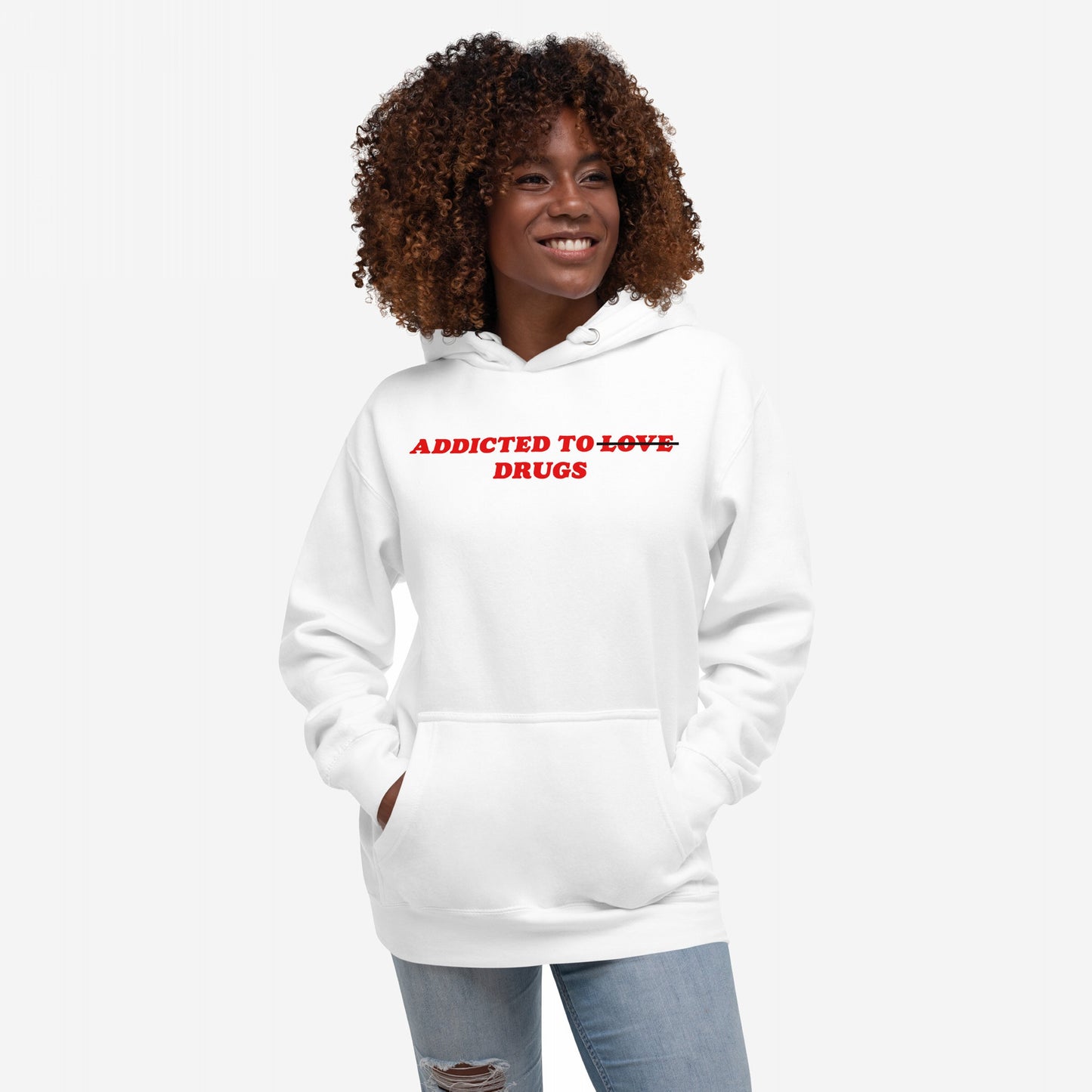Model wearing the Addicted To Love / Drugs Hoodie EU, featuring bold red text with LOVE crossed out and DRUGS. Pairs humor with comfort, designed for mental health awareness. Ideal for those embracing coping.