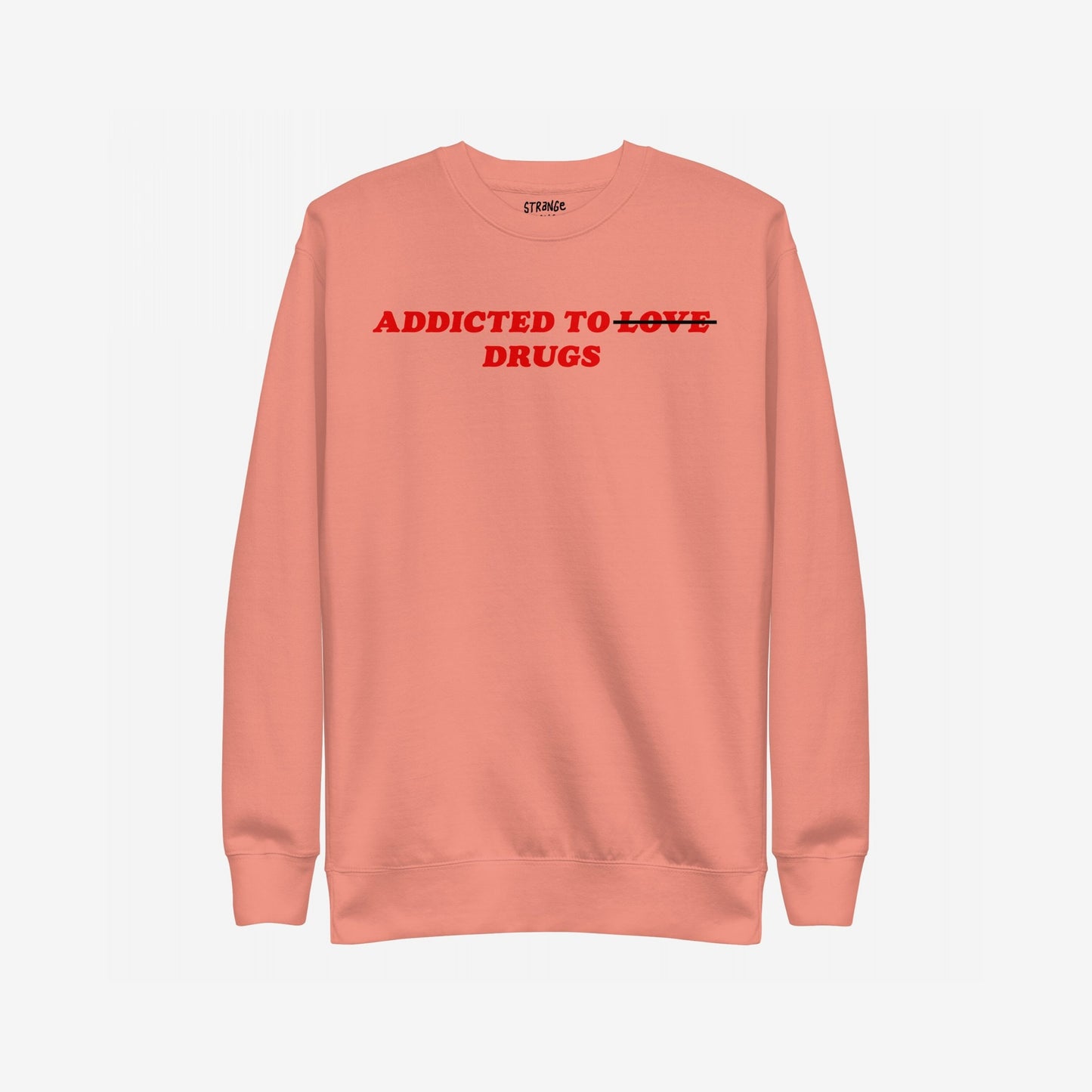 The Addicted To Love / Drugs Sweatshirt EU features bold red text on a salmon-pink crewneck, humorously striking through LOVE to highlight DRUGS, embodying Egoproof’s candid mental health messaging.
