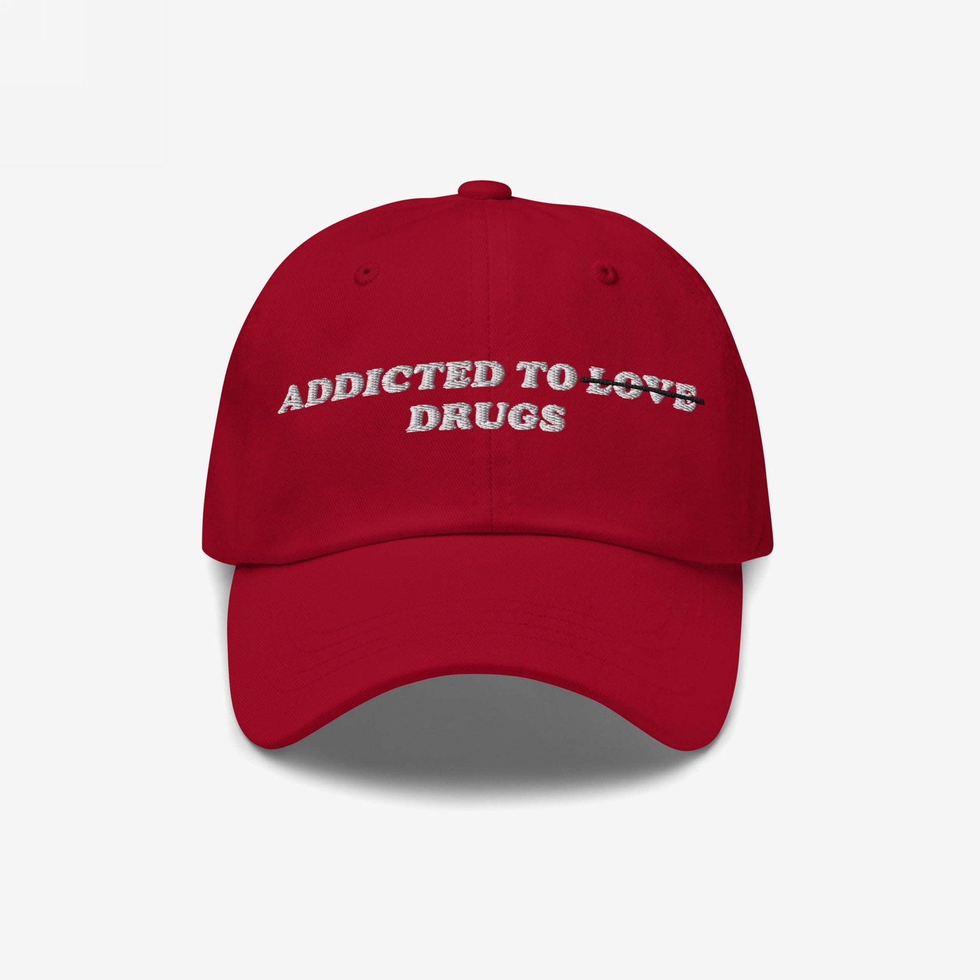 The Egoproof Addicted To Love / Drugs Hat is a red snapback with bold white embroidered text on the front, making a mental health statement. It’s shown against a plain white background.