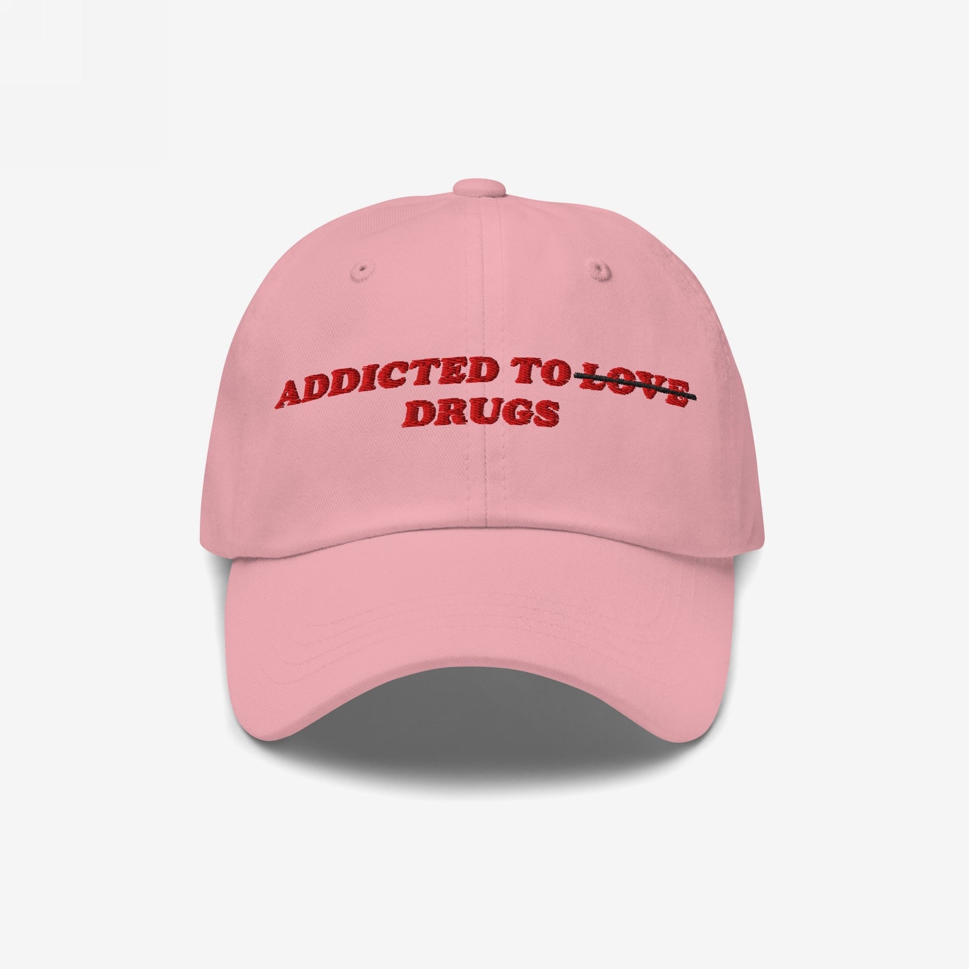 The Egoproof Addicted To Love / Drugs Hat features pink fabric with red embroidery—LOVE crossed out for DRUGS—making a bold mental health statement. This snapback’s standout design ensures you’ll get noticed in any crowd.