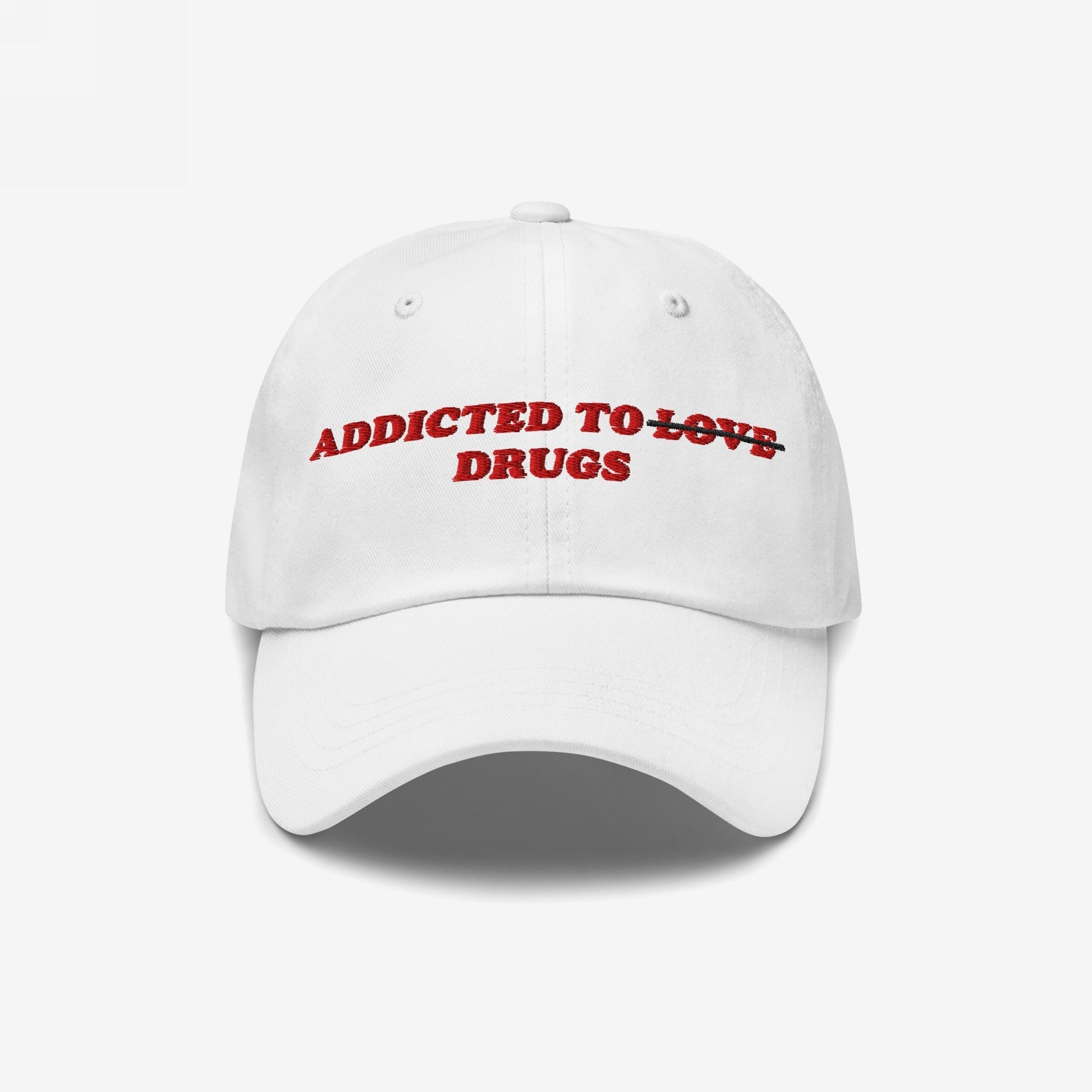 The Egoproof Addicted To Love / Drugs Hat is a white snapback with red embroidered text—LOVE is crossed out for DRUGS—making a bold mental health statement.