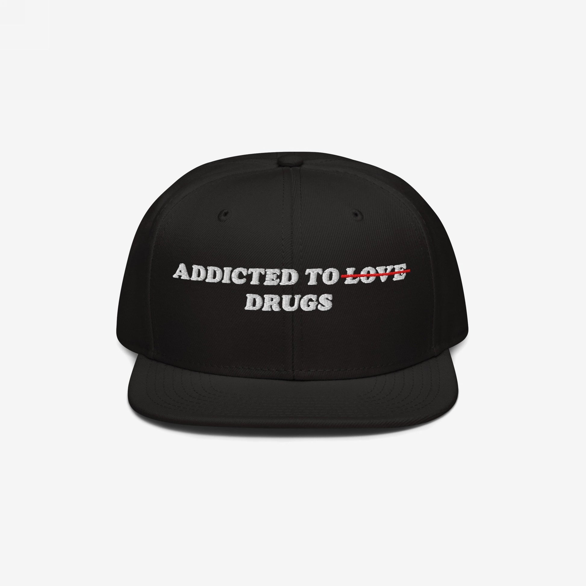 The Egoproof Addicted To Love / Drugs Hat is a black snapback with ADDICTED TO LOVE DRUGS embroidered on the front, LOVE crossed out in red—a bold mental health statement that puts the focus on DRUGS.