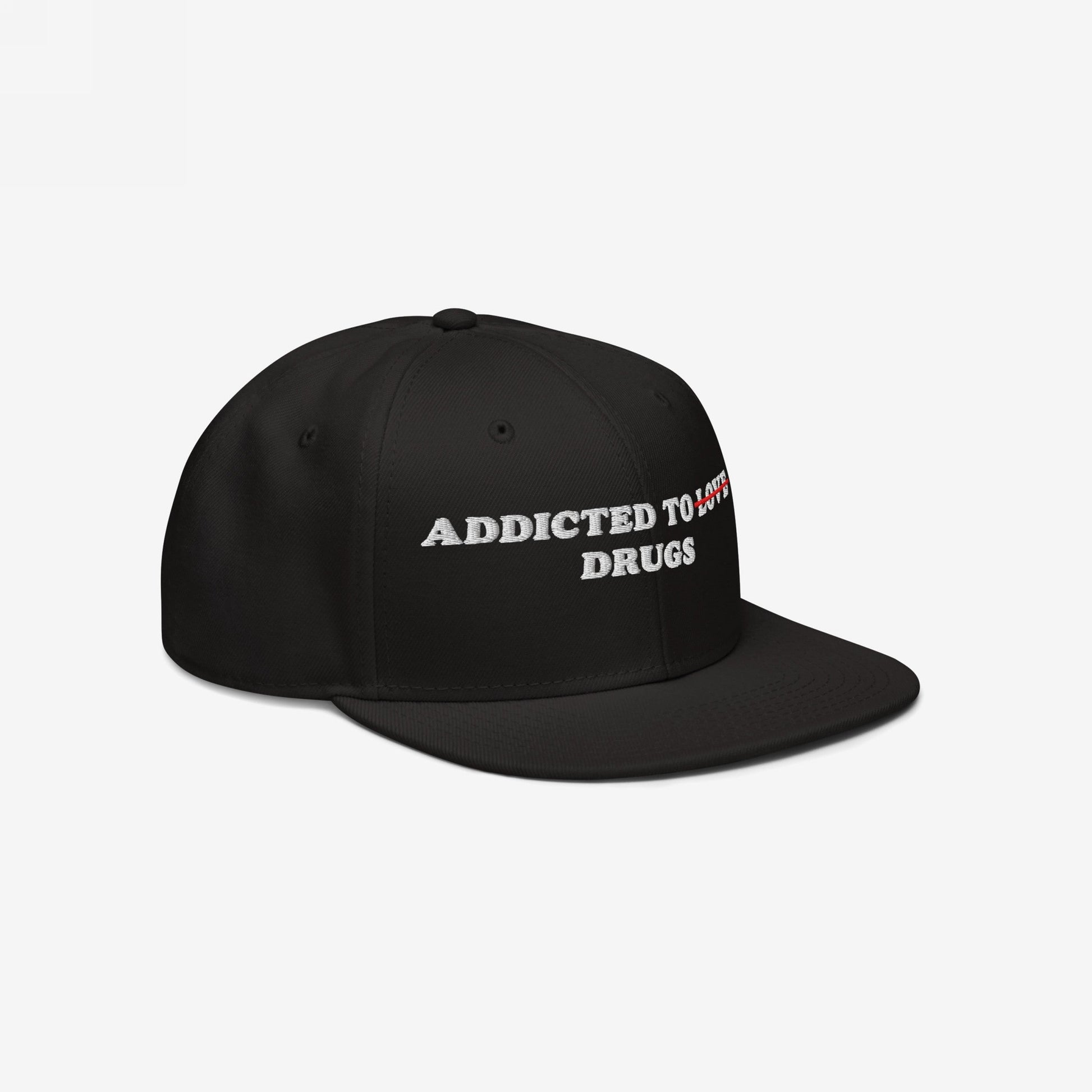 The Egoproof Addicted To Love / Drugs Hat is a black embroidered snapback featuring ADDICTED TO LOVE with LOVE in red crossed out and replaced by DRUGS in white, shown on a plain white background.
