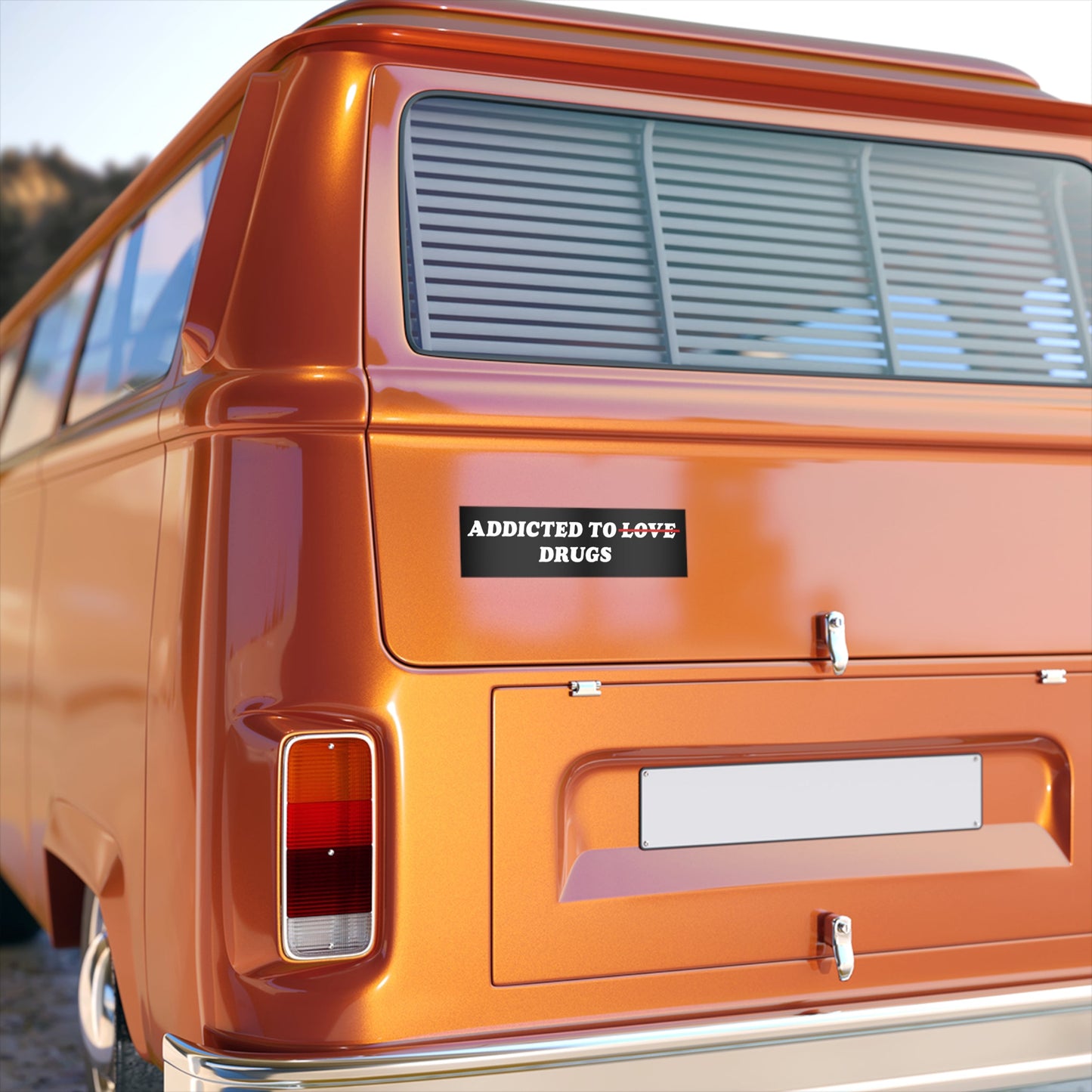 The rear of an orange retro van displays an Addicted To Love / Drugs Sticker & Magnet, humorously replacing LOVE with DRUGS, reflecting a quirky, mental health-themed message in durable vinyl.