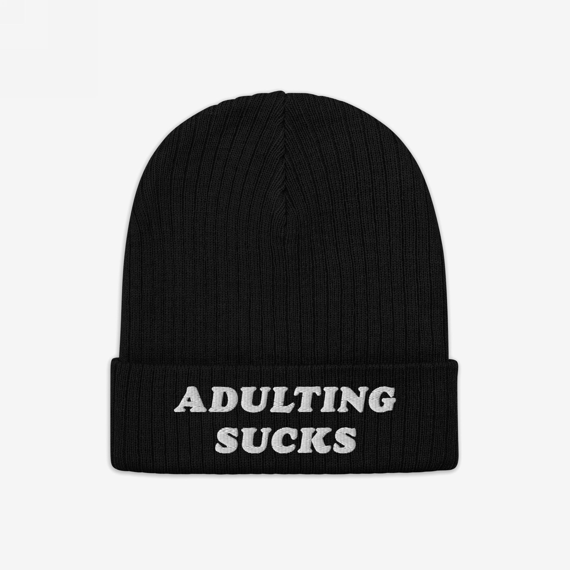 Black rib-knit beanie with folded cuff, featuring ADULTING SUCKS in white block letters. The Adulting Sucks Hat embodies a vintage-inspired, brutally honest statement for those feeling overwhelmed by adult responsibilities.