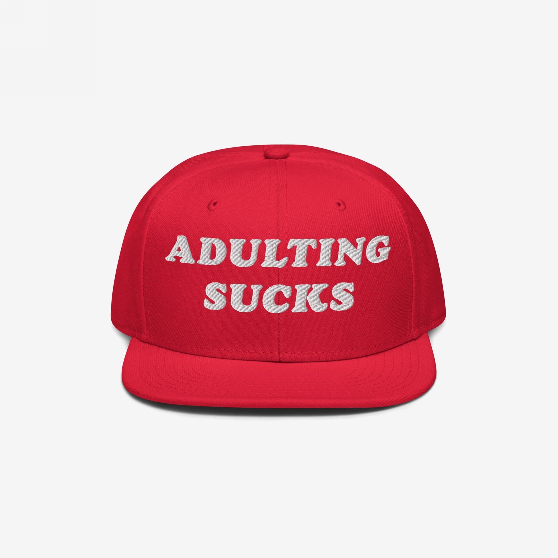 Adulting Sucks Hat: A bold red snapback featuring white embroidered ADULTING SUCKS text, perfect for expressing frustration with life's challenges, aligning with Egoproof's mission of making powerful statements.
