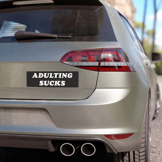 Rear view of a silver hatchback featuring the Adulting Sucks bumper sticker, symbolizing exhaustion. Ideal for cars, laptops, or workspaces, reflecting relatable sentiments with all-weather durability in a matte finish.