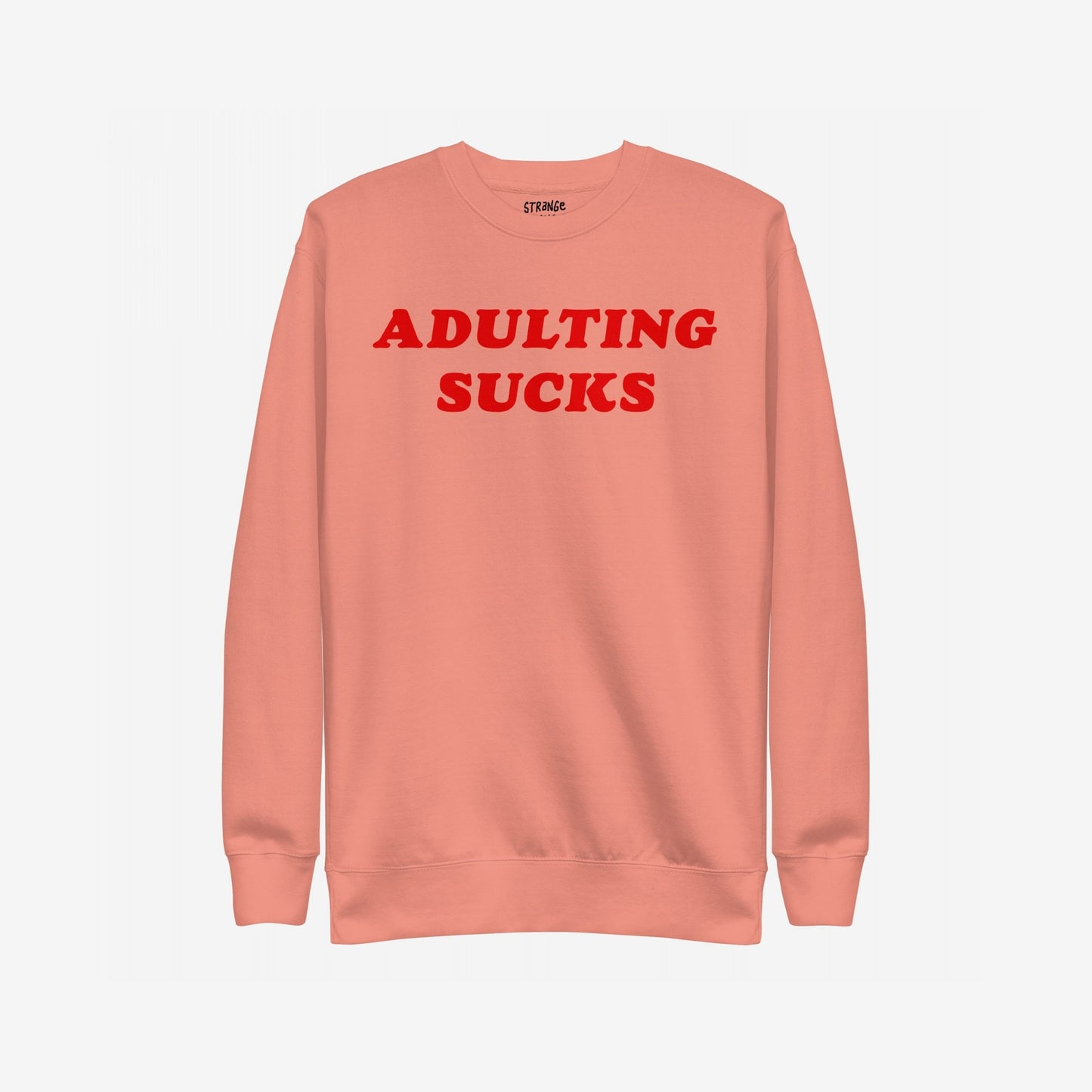 Adulting Sucks Sweatshirt EU featuring bold red text ADULTING SUCKS on a salmon-coral crewneck, ideal for expressing burnout and humor, reflecting Egoproof's mental health-focused apparel ethos.