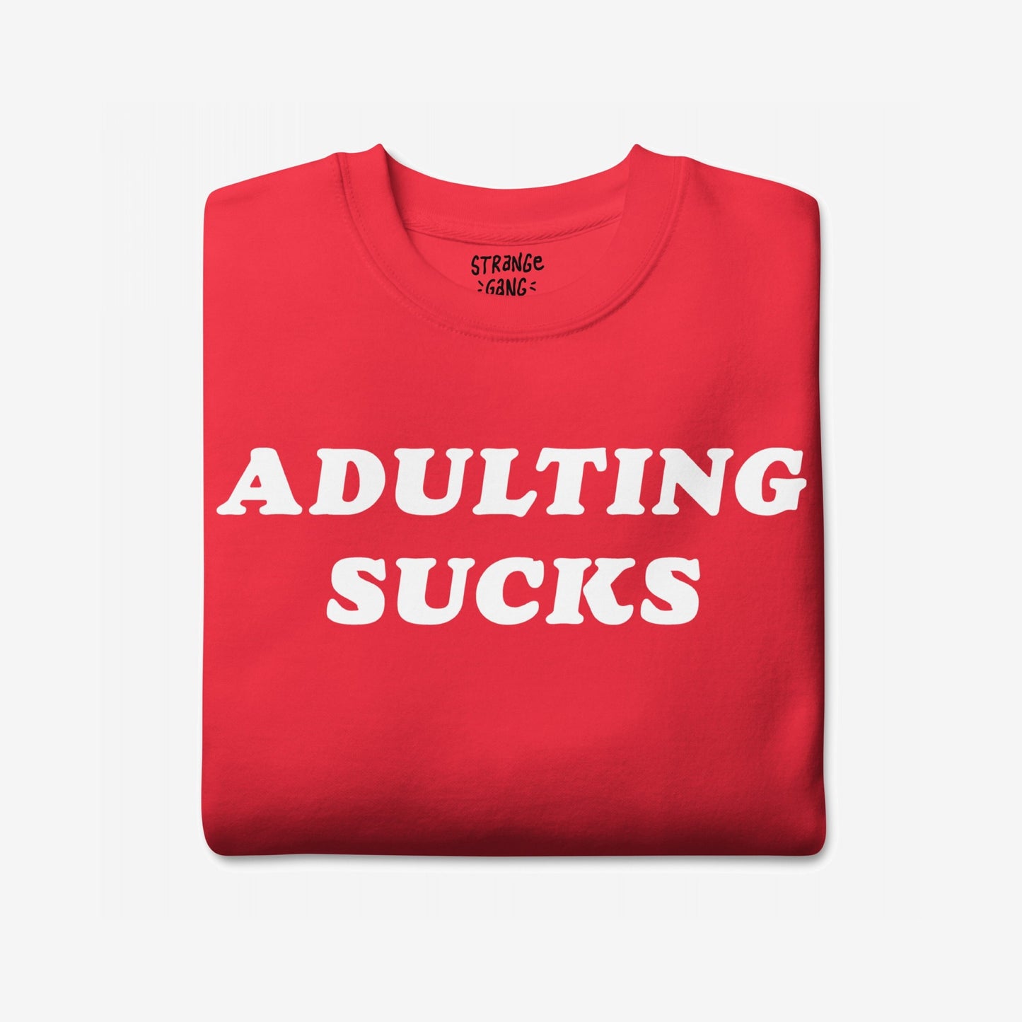 Adulting Sucks Sweatshirt EU: A folded red crewneck with bold white ADULTING SUCKS text on the front, perfect for expressing the stress and humor of modern adult life.