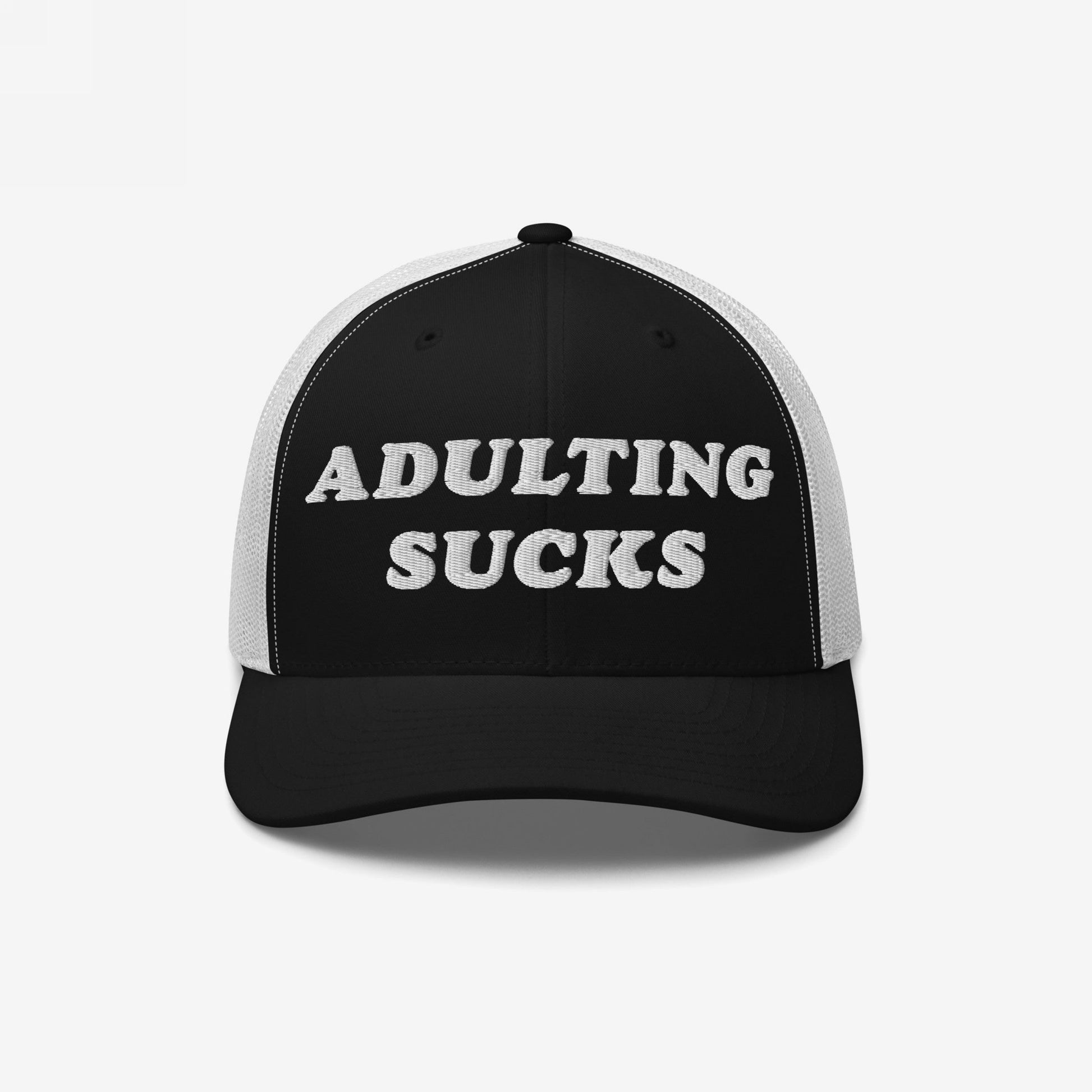Adulting Sucks Hat: A black-and-white mesh trucker cap featuring ADULTING SUCKS embroidered on the front. Perfect for expressing frustration with life's pressures, aligning with Egoproof's mental health advocacy.
