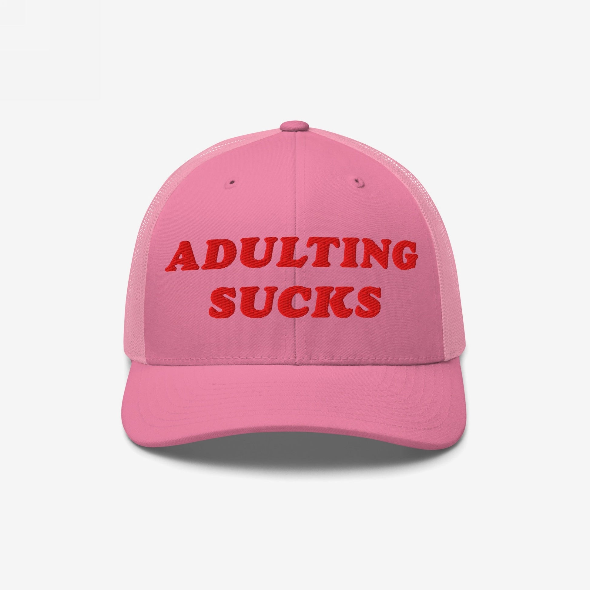 Pink trucker-style Adulting Sucks Hat with red embroidered text, expressing humor and honesty about adult responsibilities. Ideal for casual wear, it supports mental health awareness through NAMI donations.