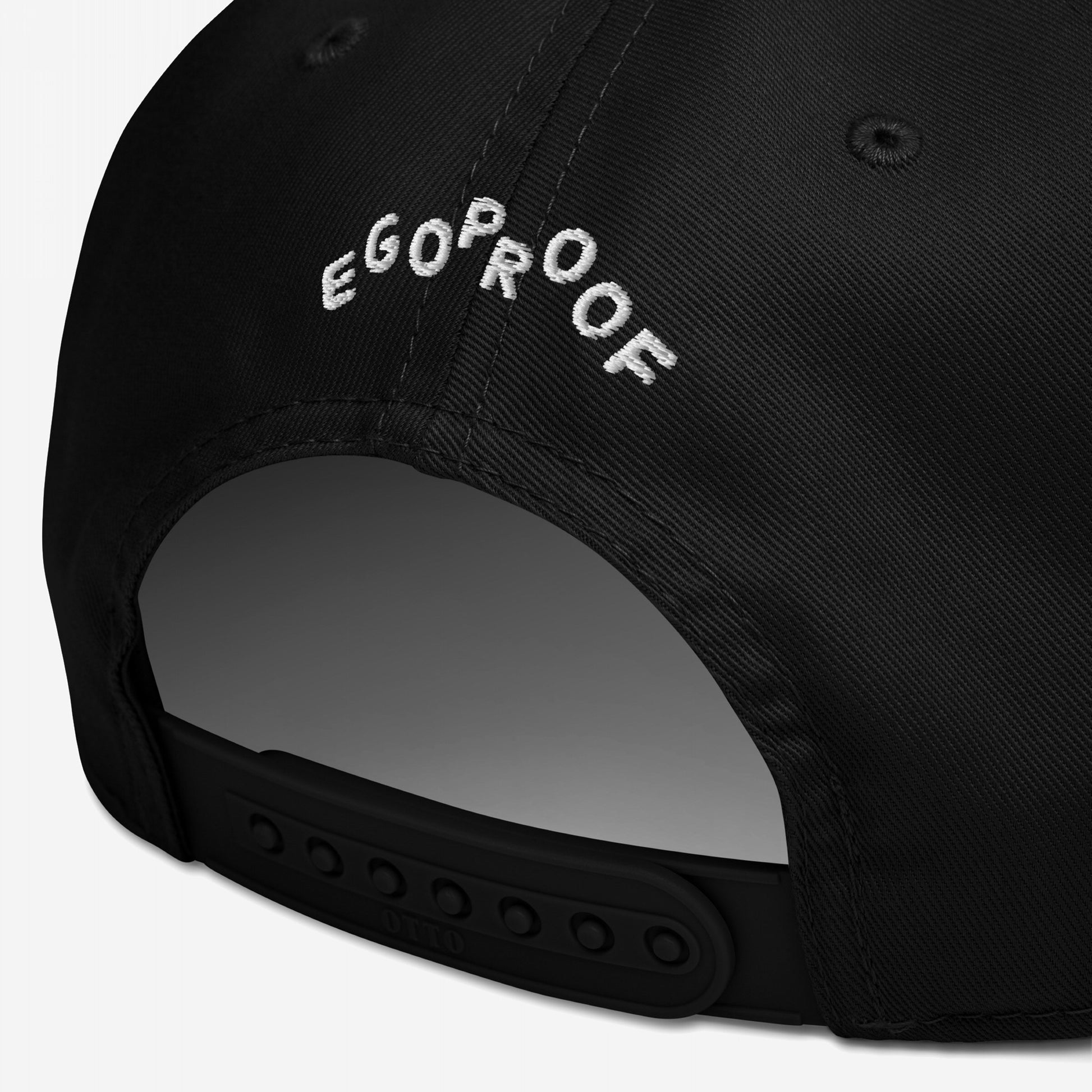 Anti-Fascist Hat rear view, showcasing white embroidered EGOPROOF text on a black, six-panel cap with a snap-back closure, embodying bold style and accountability.