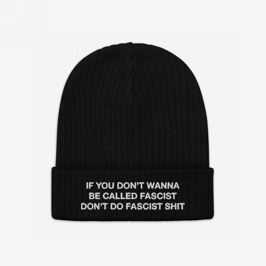 Anti-Fascist Beanie featuring a bold white embroidery: “IF YOU DON’T WANNA BE CALLED FASCIST DON’T DO FASCIST SHIT.” A rib-knit design with folded cuff, embodying defiant style and resistance.