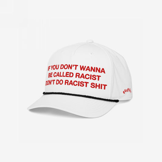 Anti-Racist Hat by Egoproof: A white cap with bold red embroidery, If you don’t wanna be called racist, don’t do racist shit, featuring a black rope trim and EGOPROOF side embroidery.