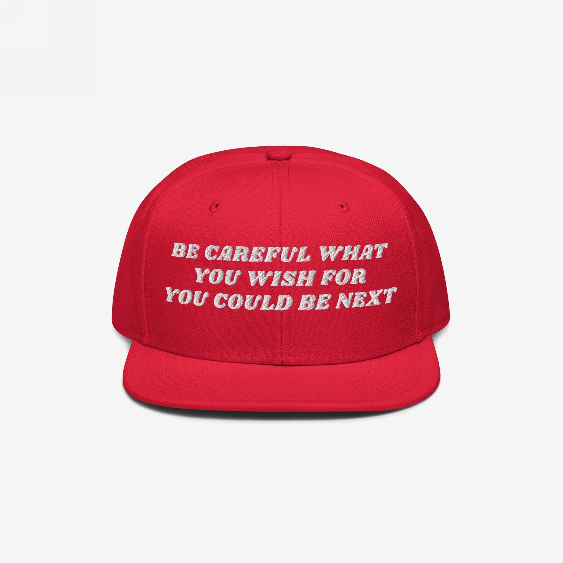 Bright red snapback cap with the bold white embroidered text BE CAREFUL WHAT YOU WISH FOR YOU COULD BE NEXT., titled Be Careful Hat, ideal for making powerful anti-extremism statements.