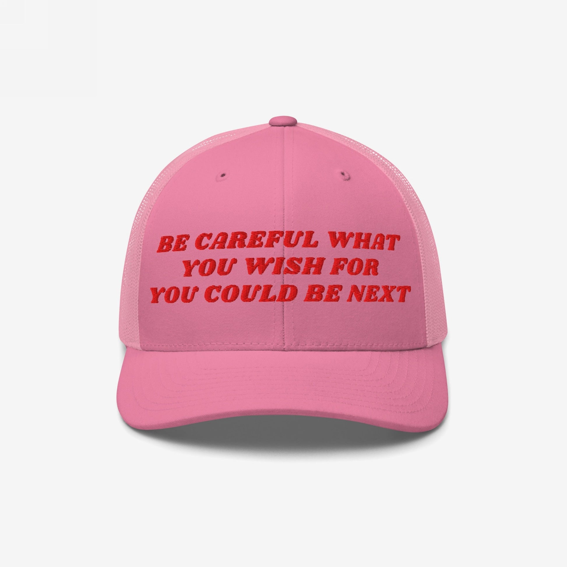 Be Careful Hat: A pink trucker-style cap with bold red embroidery stating “BE CAREFUL WHAT YOU WISH FOR YOU COULD BE NEXT,” reflecting a bold, progressive statement. Ideal for protests and everyday wear.