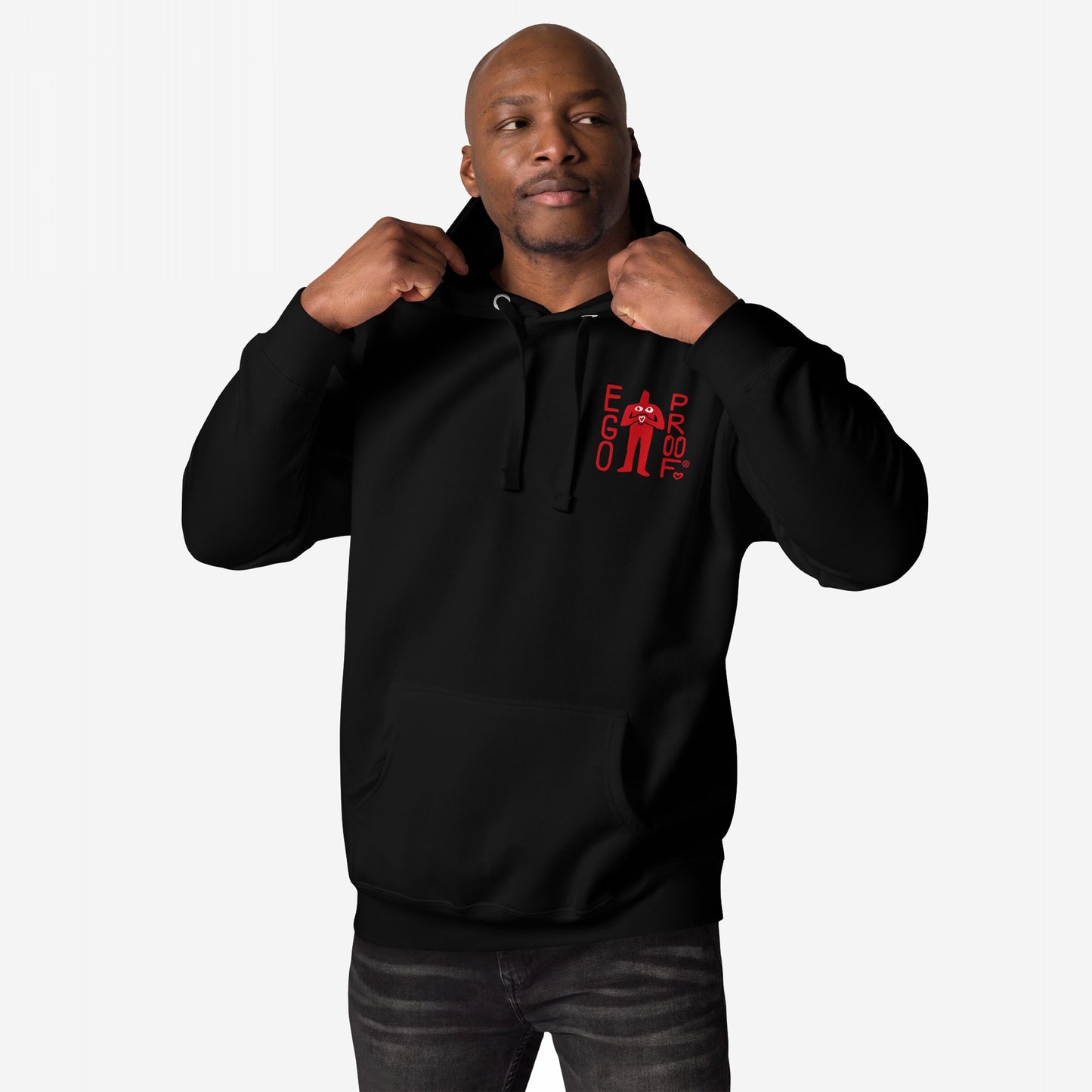Male model wearing the Fucks To Give Hoodie EU, featuring a small red EGO PROOF graphic on the chest, holding drawstrings. Ideal for embracing selective apathy and comfort on mentally checked-out days.