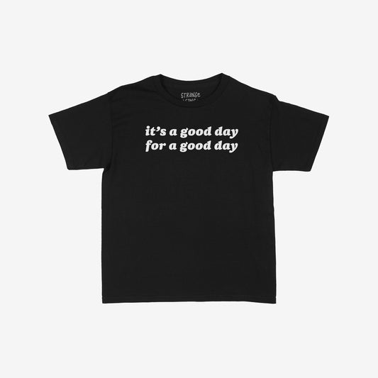 Good Day Women's Baby Tee features it’s a good day for a good day. slogan in white on a fitted black T-shirt, offering daily optimism and style for mindset shifts and mood lifts.