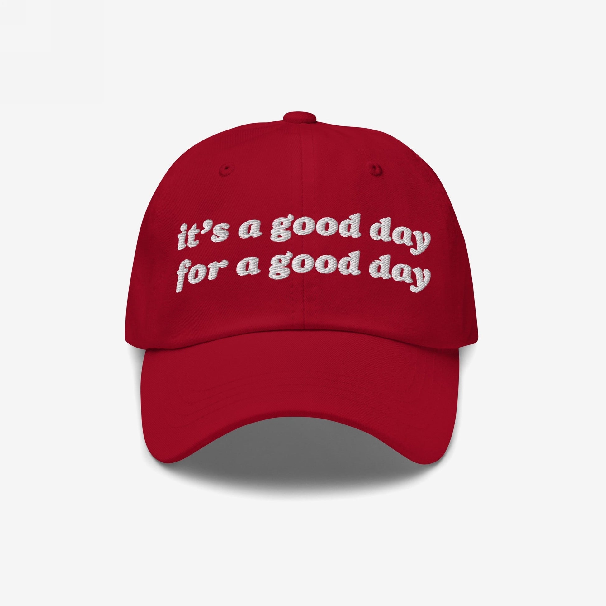Red baseball-style Good Day Hat with white embroidered text reading, “it’s a good day for a good day.” Ideal for positivity advocates, available in various styles, supporting mental health awareness through NAMI.