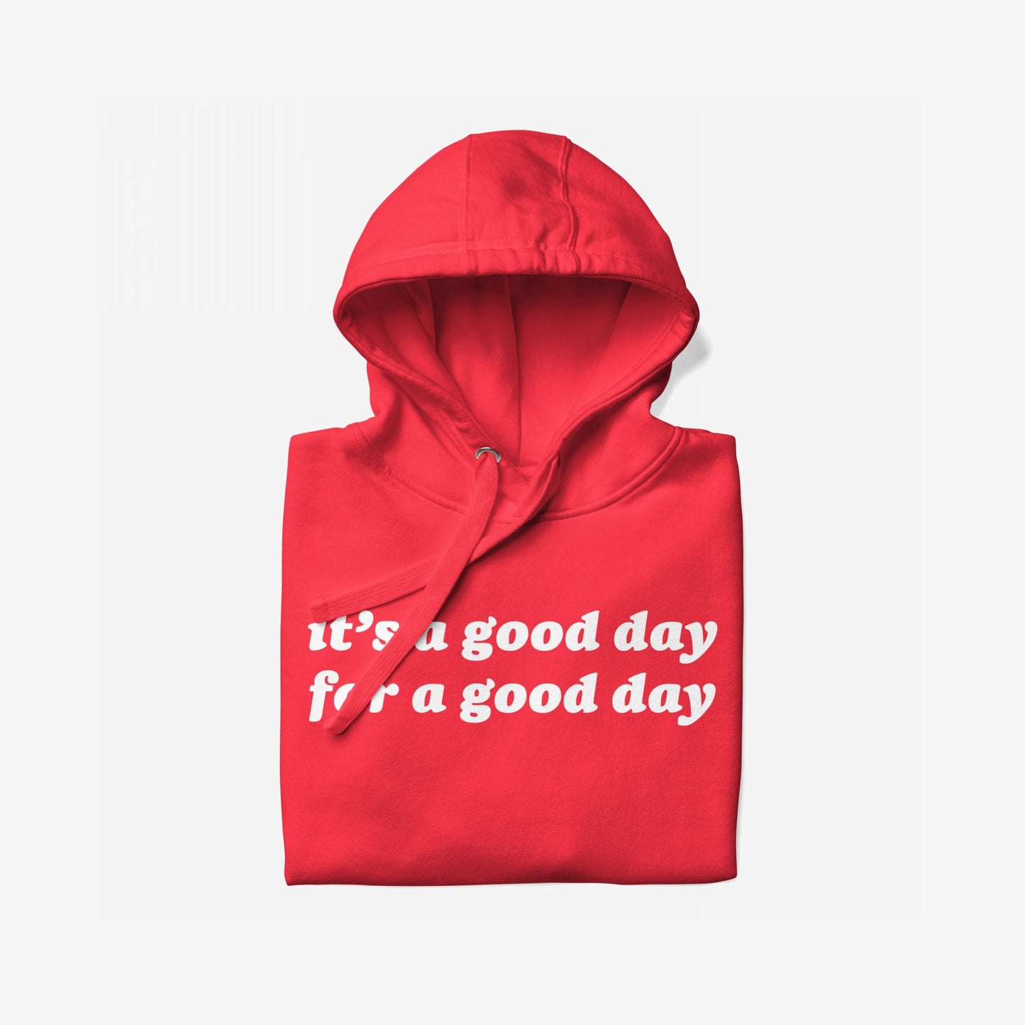 The Good Day Hoodie EU features a folded red hoodie with white lettering stating “It’s a good day for a good day,” symbolizing comfort and hope, supporting mental health initiatives.