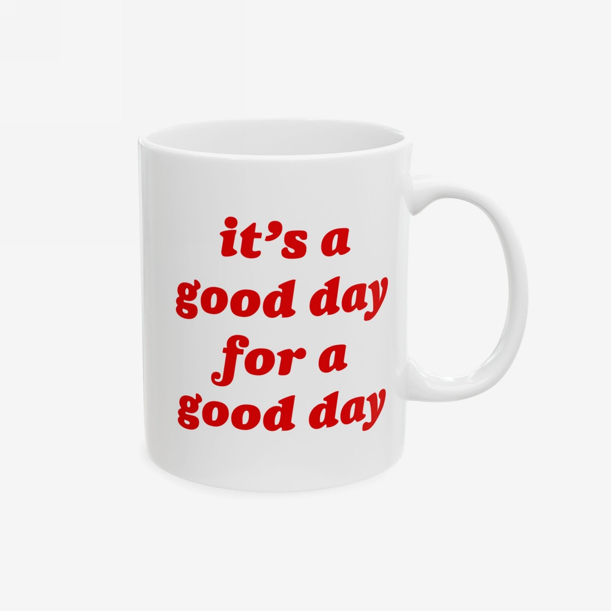White ceramic Good Day Mug with bold red letters reading “it’s a good day for a good day.” Ideal for boosting optimism, available in 11 oz. and 15 oz. sizes, supporting mental health awareness.