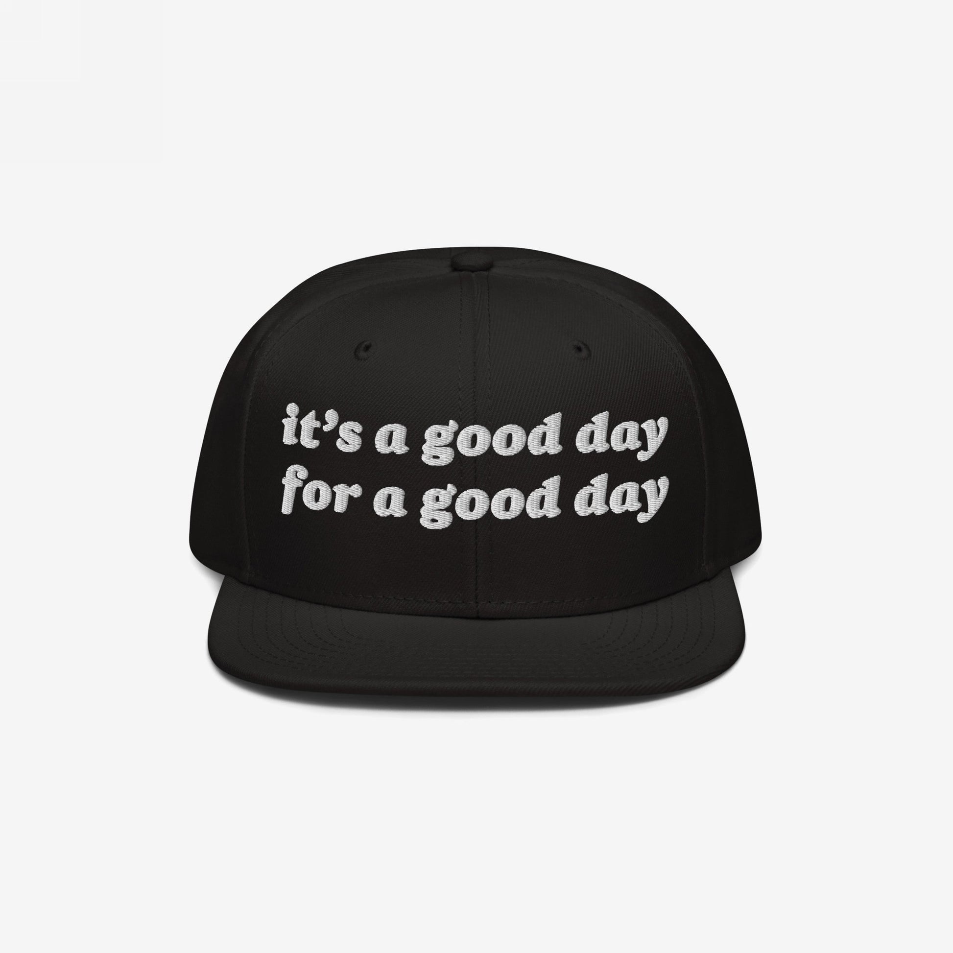 Black flat-brimmed snapback hat with white embroidered text: “it’s a good day for a good day.” The Good Day Hat promotes positivity, perfect for mental health advocates and positivity enthusiasts.
