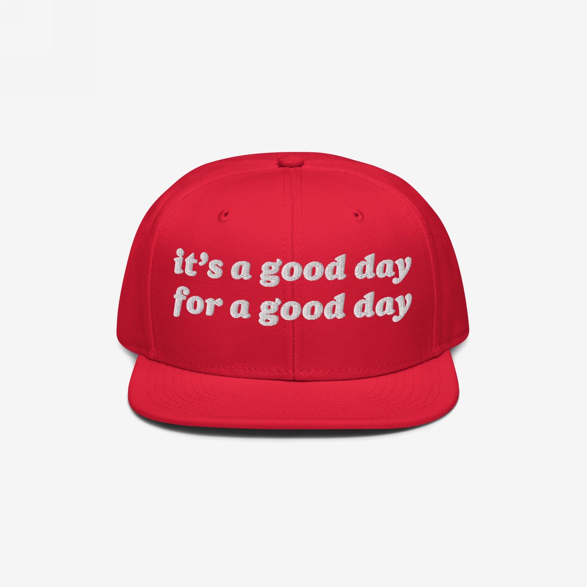 The Good Day Hat features a flat-brimmed, snapback design with white embroidery stating it’s a good day for a good day, promoting positivity and mental health awareness.