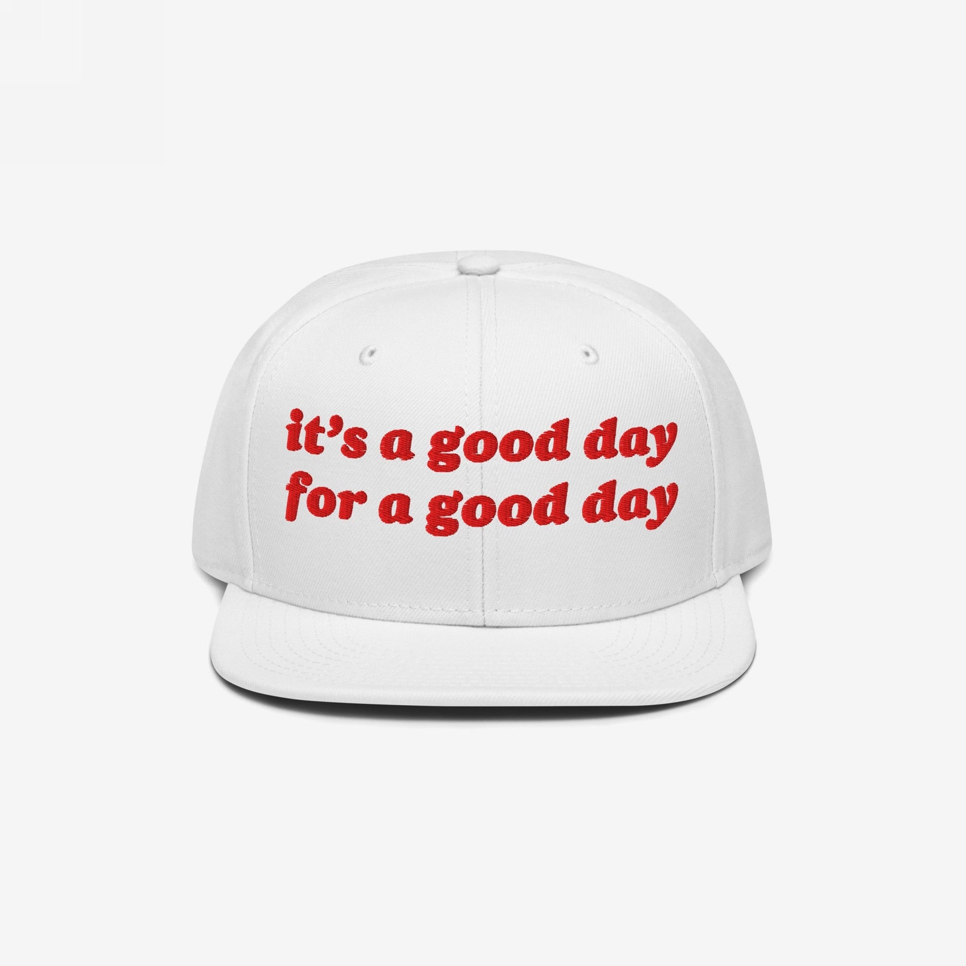 The Good Day Hat features a bold red embroidered message, it’s a good day for a good day, on the front of a white snapback, promoting positivity and mental health advocacy.