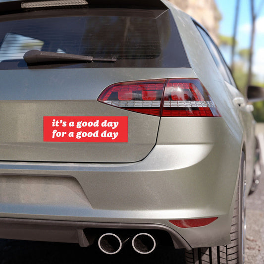Good Day Sticker & Magnet on a hatchback's tailgate, featuring the motivational message, “it’s a good day for a good day” in white text on a red background, suggesting encouragement and resilience.