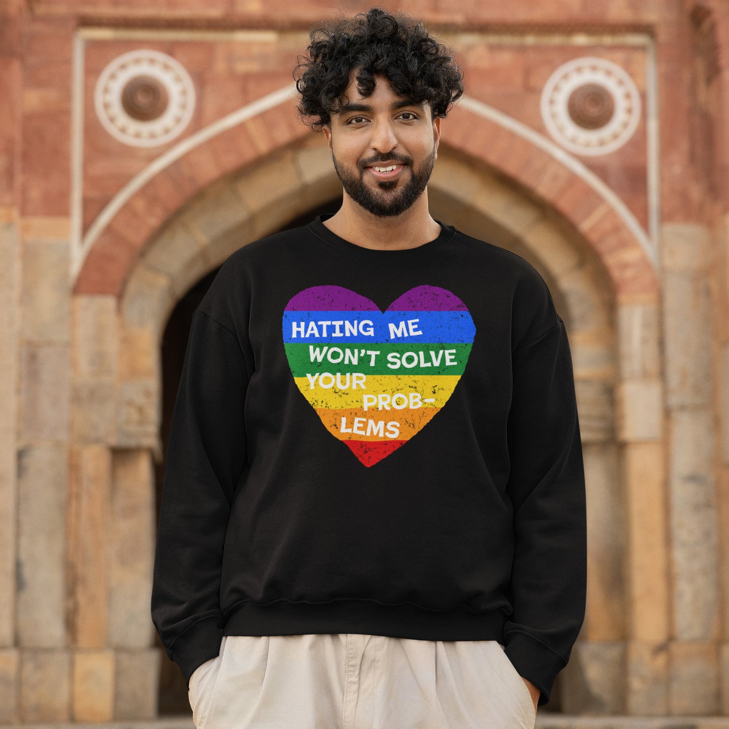 Man wearing No LGBTQ Hate Hoodie & Sweatshirt with rainbow heart and message about resilience for LGBTQ+ pride and inclusion.