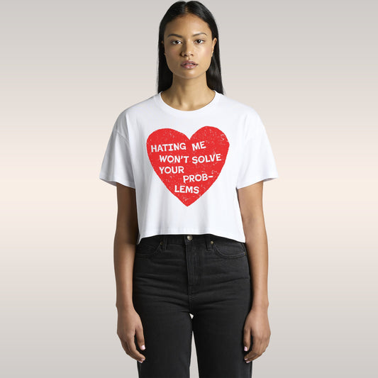 Woman wearing a black No Hate Women's Baby Tee with a red heart and message Hating Me Won't Solve Your Problems cut to fit st