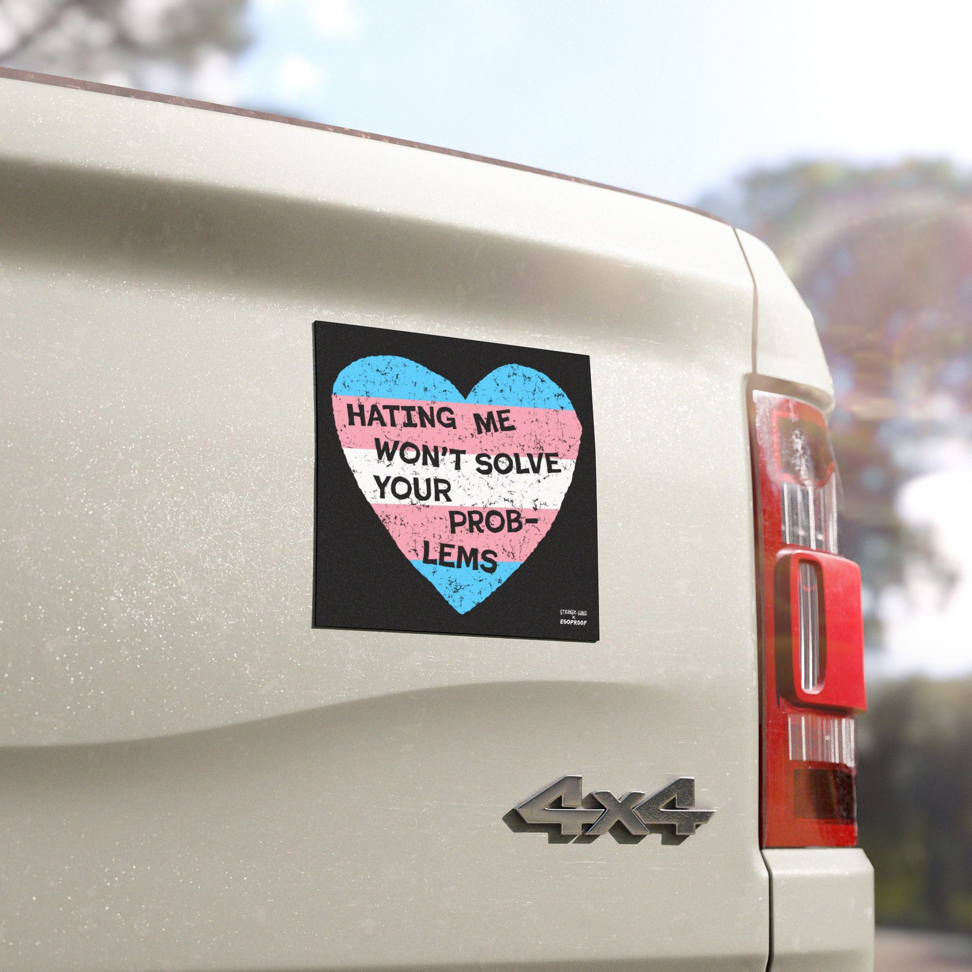 No Trans Hate Sticker & Magnet showing trans flag heart with "Hating Me Won’t Solve Your Problems" on a white 4x4 vehicle.