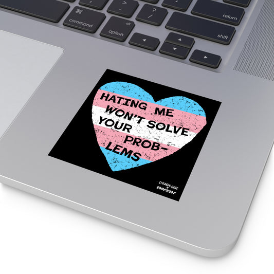 No Trans Hate Sticker & Magnet showing trans flag heart with "Hating Me Won't Solve Your Problems" on laptop surface.