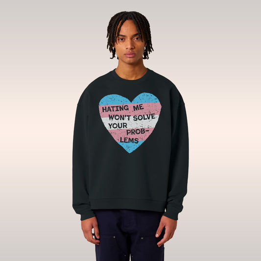 Person wearing black No Trans Hate Hoodie & Sweatshirt with trans flag heart and message "Hating Me Won't Solve Your Problems