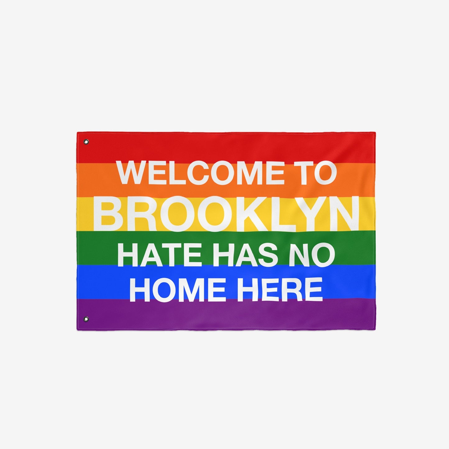 Custom Hate Has No Home Here Pride Flag with horizontal rainbow stripes and bold white text, promoting inclusion and acceptance. Personalize with city name; available in various sizes for homes or events.