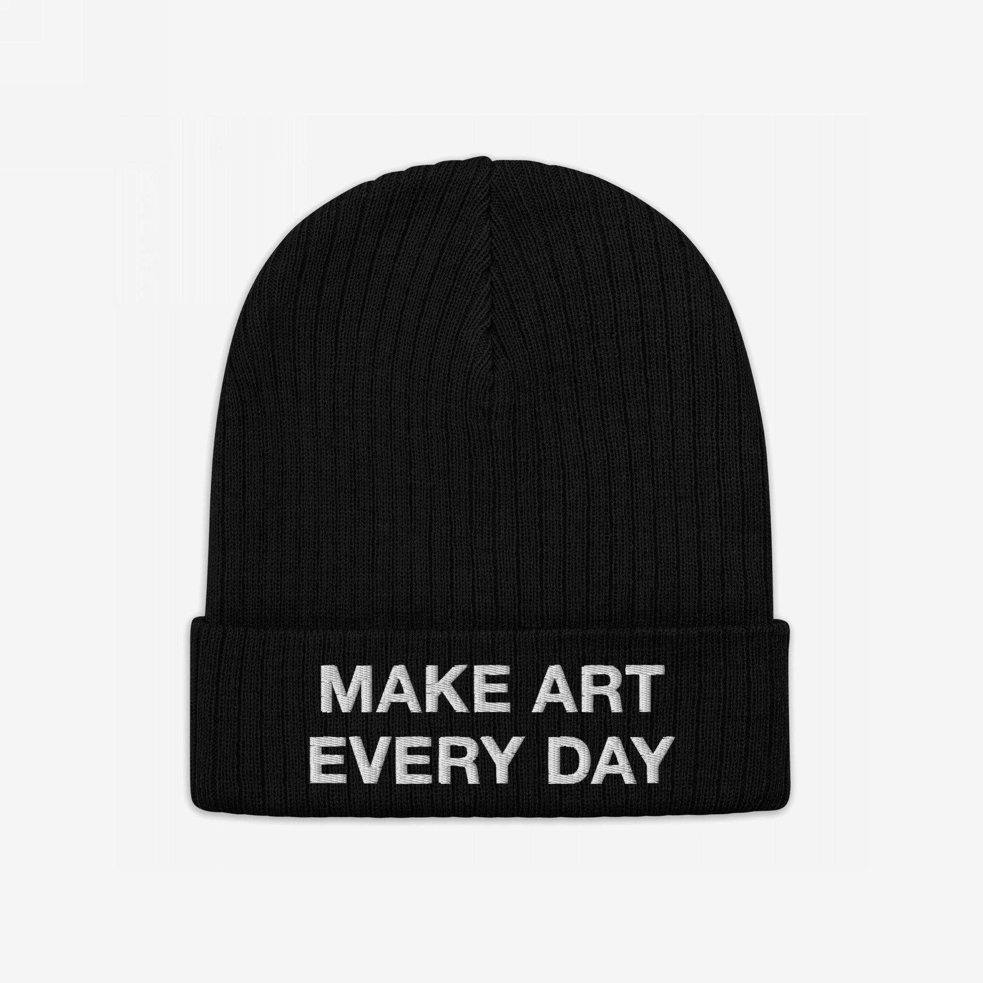 Make Art Every Day Beanie shows a black knitted cuff-style hat with the phrase “MAKE ART EVERY DAY” embroidered in white, inspiring creativity and warmth for artists in any setting.