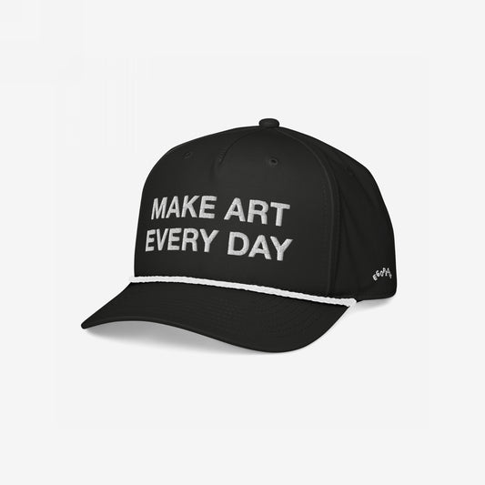 Make Art Every Day Hat: Black trucker-style cap with “MAKE ART EVERY DAY” embroidered on the front, white braided rope above the brim, and EGOPROOF branding on the side. Mid-profile, adjustable for comfort.