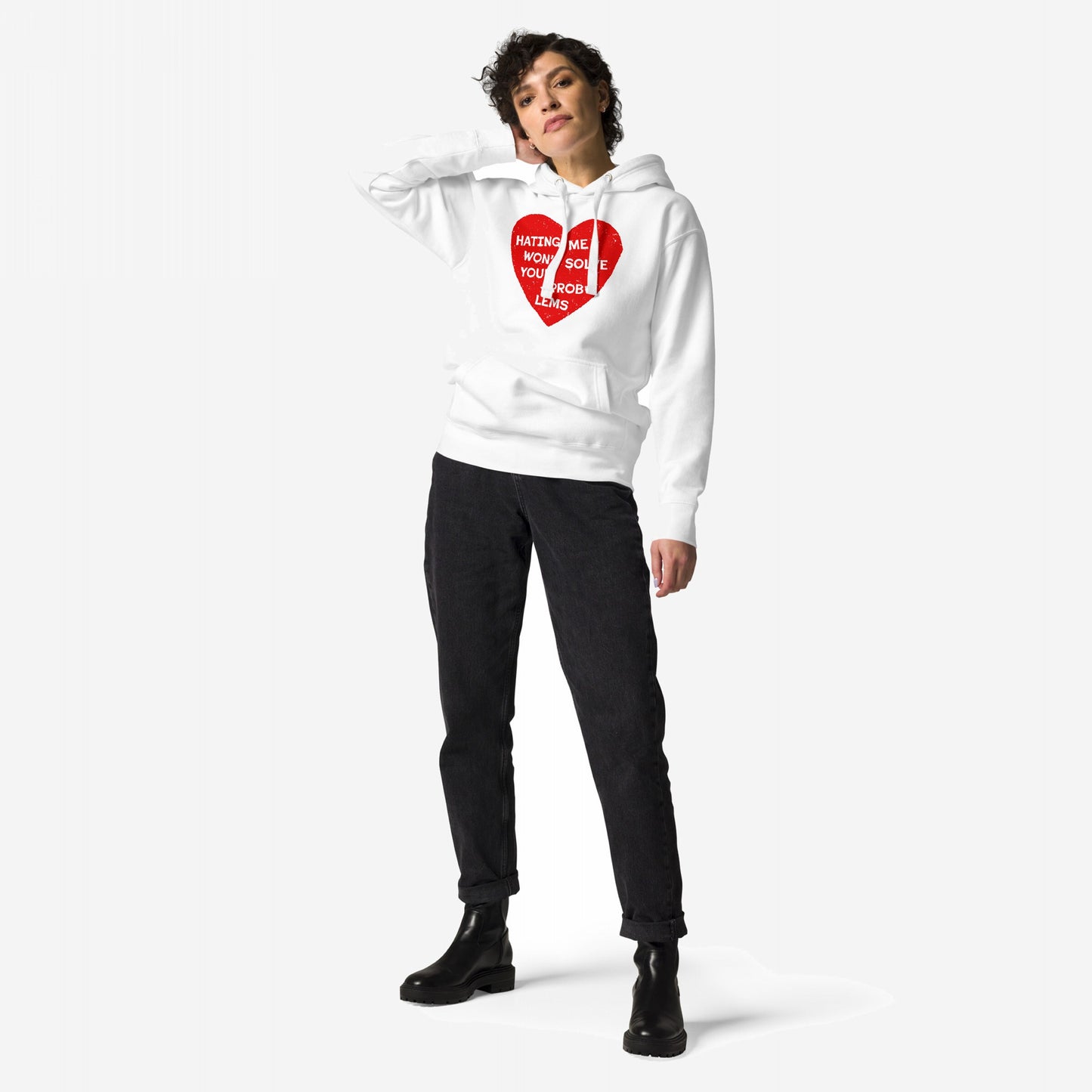 Woman models the No Hate Hoodie EU, featuring a distressed red heart with “Hating Me Won’t Solve Your Problems” text, paired with black jeans and chunky boots, embodying Egoproof’s bold, statement-driven style.