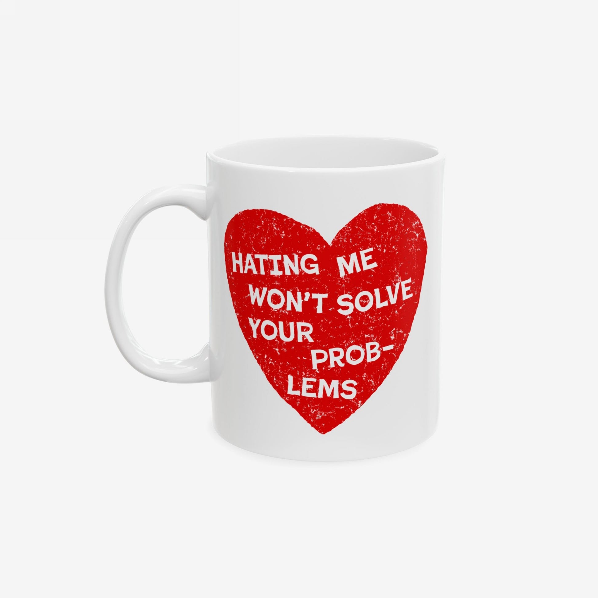 No Hate Mug with red heart and quote "Hating me won’t solve your problems" on white ceramic coffee cup with handle.