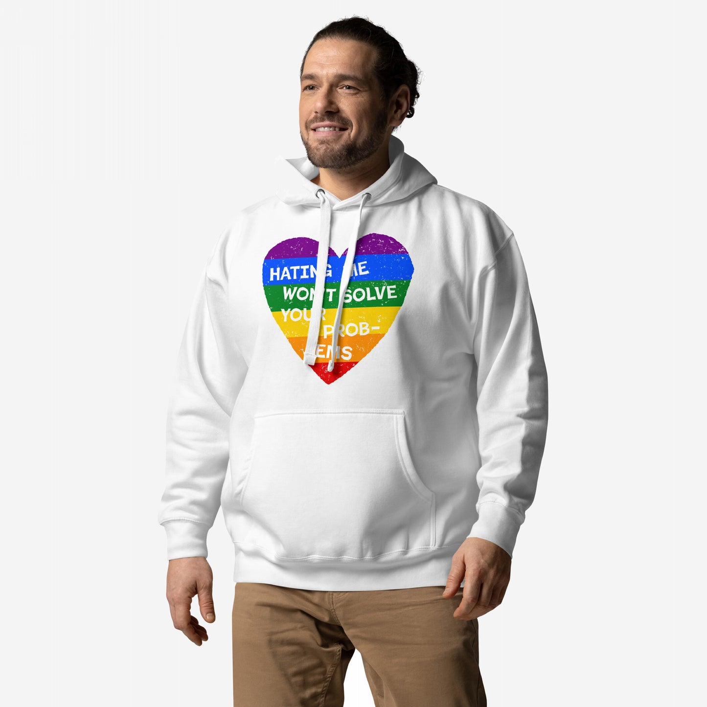 No LGBTQ Hate Hoodie EU features a rainbow heart with Hating Me Won’t Solve Your Problems slogan, worn by a smiling man, embodying pride and resilience against a light background.