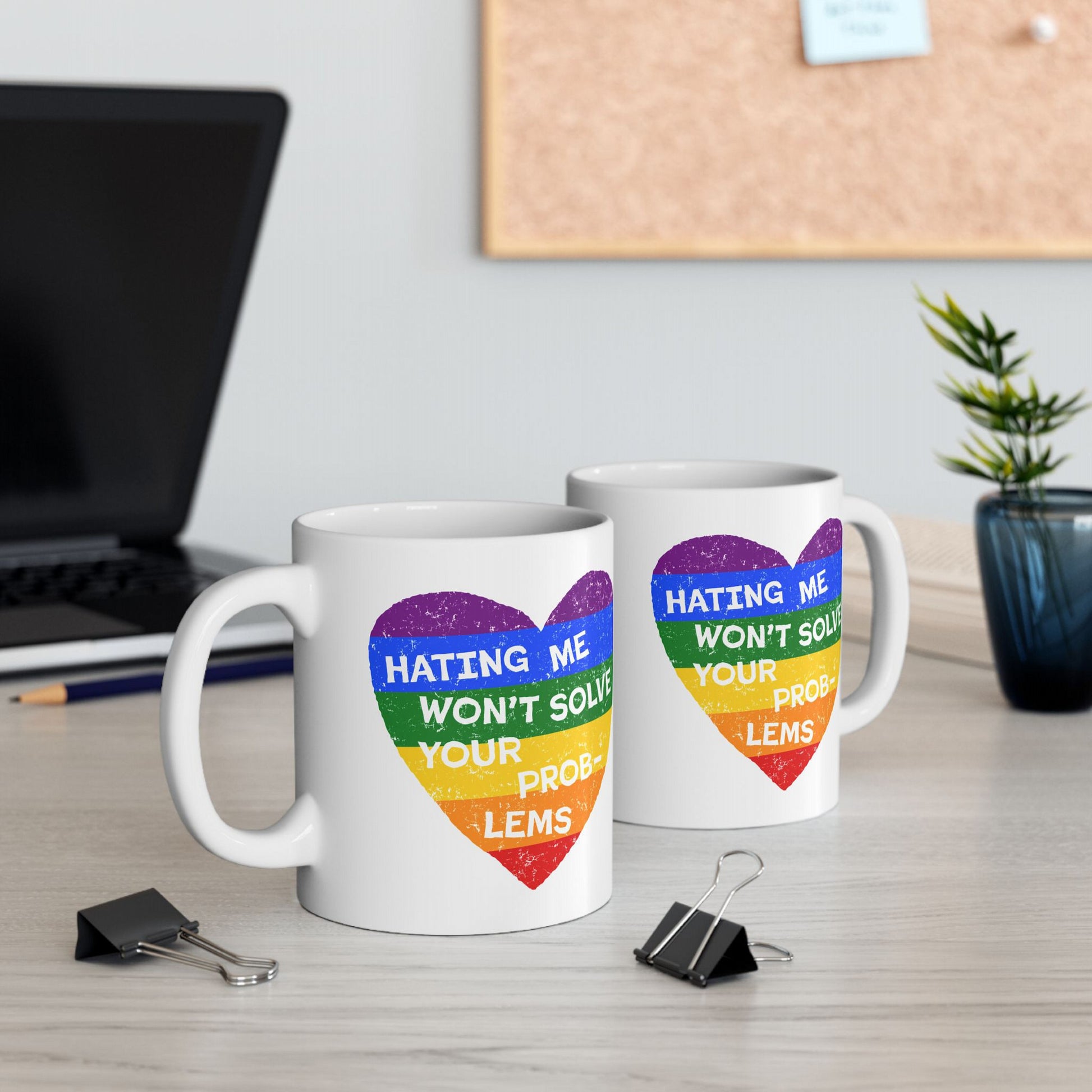 No LGBTQ Hate Mug featuring a rainbow heart with the quote "Hating Me Won’t Solve Your Problems" on a white ceramic mug.