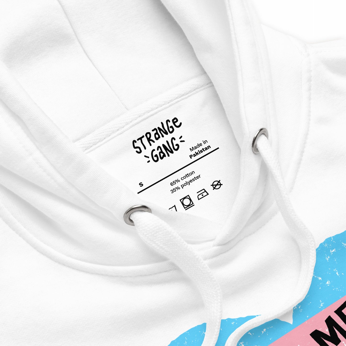 No Trans Hate Hoodie EU: Close-up of white hoodie neck with printed label. Features white drawcords and part of blue-pink graphic, promoting trans visibility and resilience. Made in Pakistan, cotton-polyester blend.