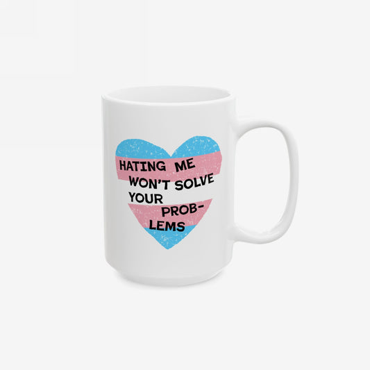 No Trans Hate Mug with a pastel-striped heart and empowering quote, showcasing bold gender identity. Ceramic, dishwasher and microwave safe, supporting trans visibility through Strange Gang collaboration.