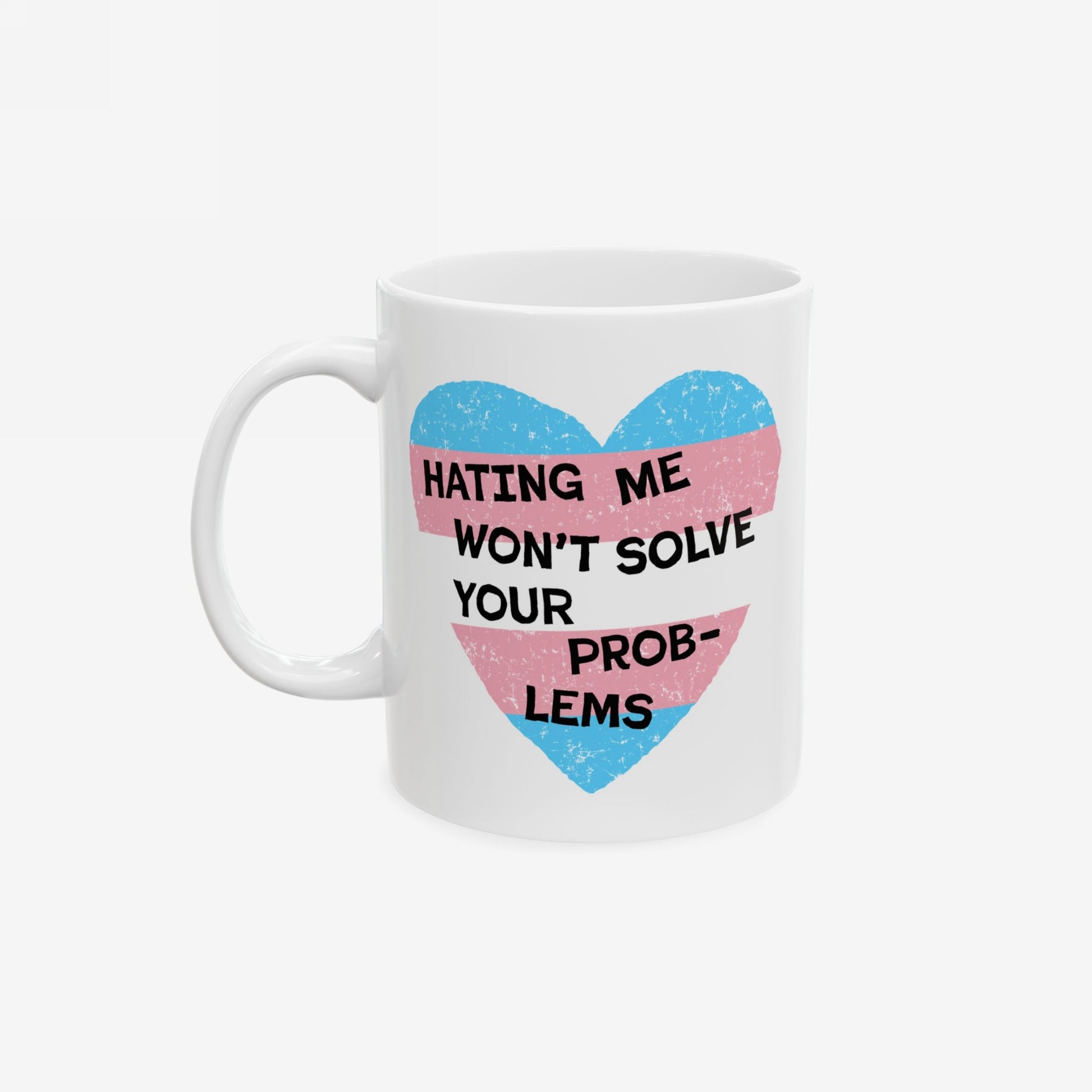 Close-up of the No Trans Hate Mug featuring a pastel-striped heart and the quote, “Hating Me Won’t Solve Your Problems,” highlighting gender identity and strength, designed for trans empowerment.