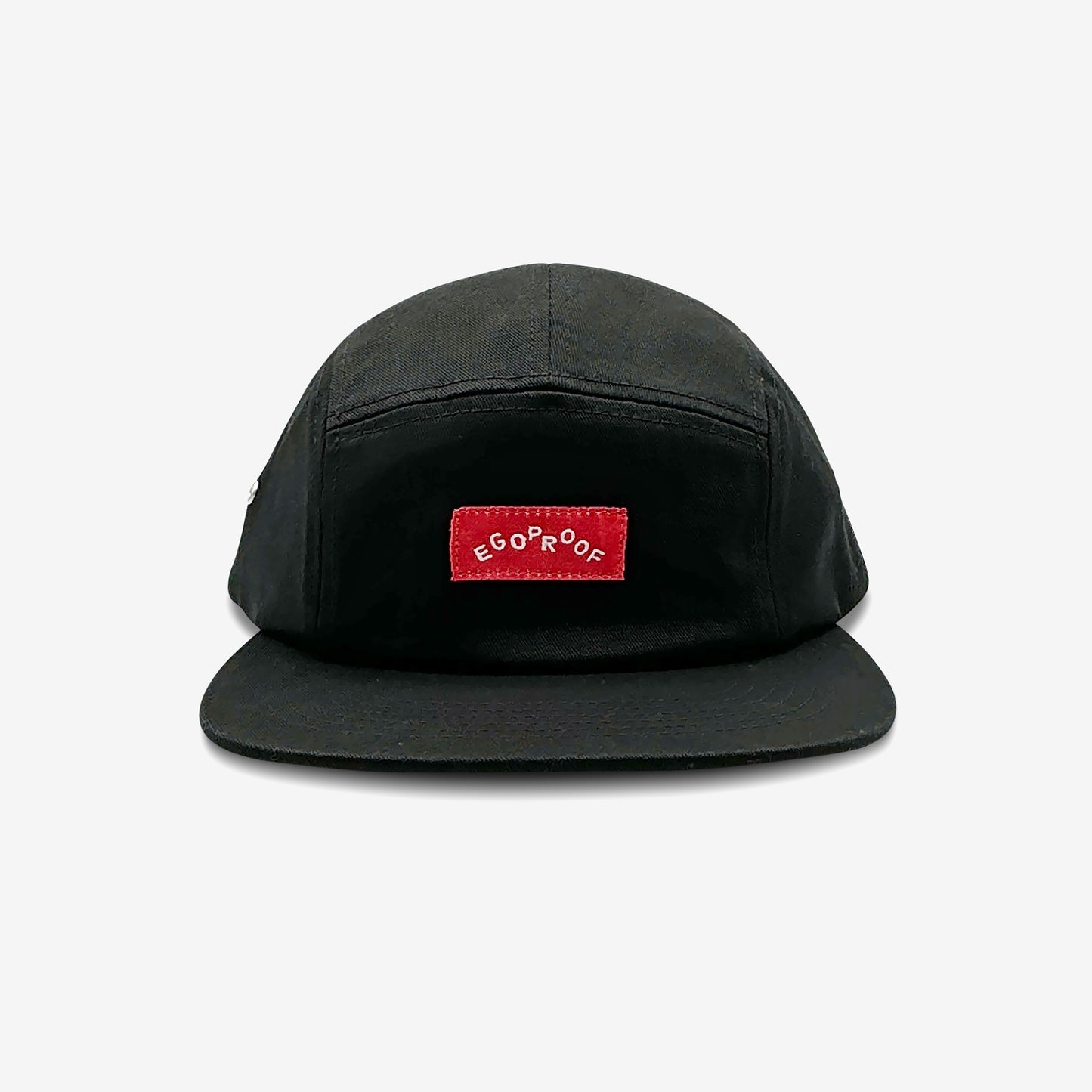 Parks Camper Hat with a red EGOPROOF woven label, featuring a low-profile 5-panel design, adjustable strap, and metal eyelets, ideal for urban and wilderness adventures.