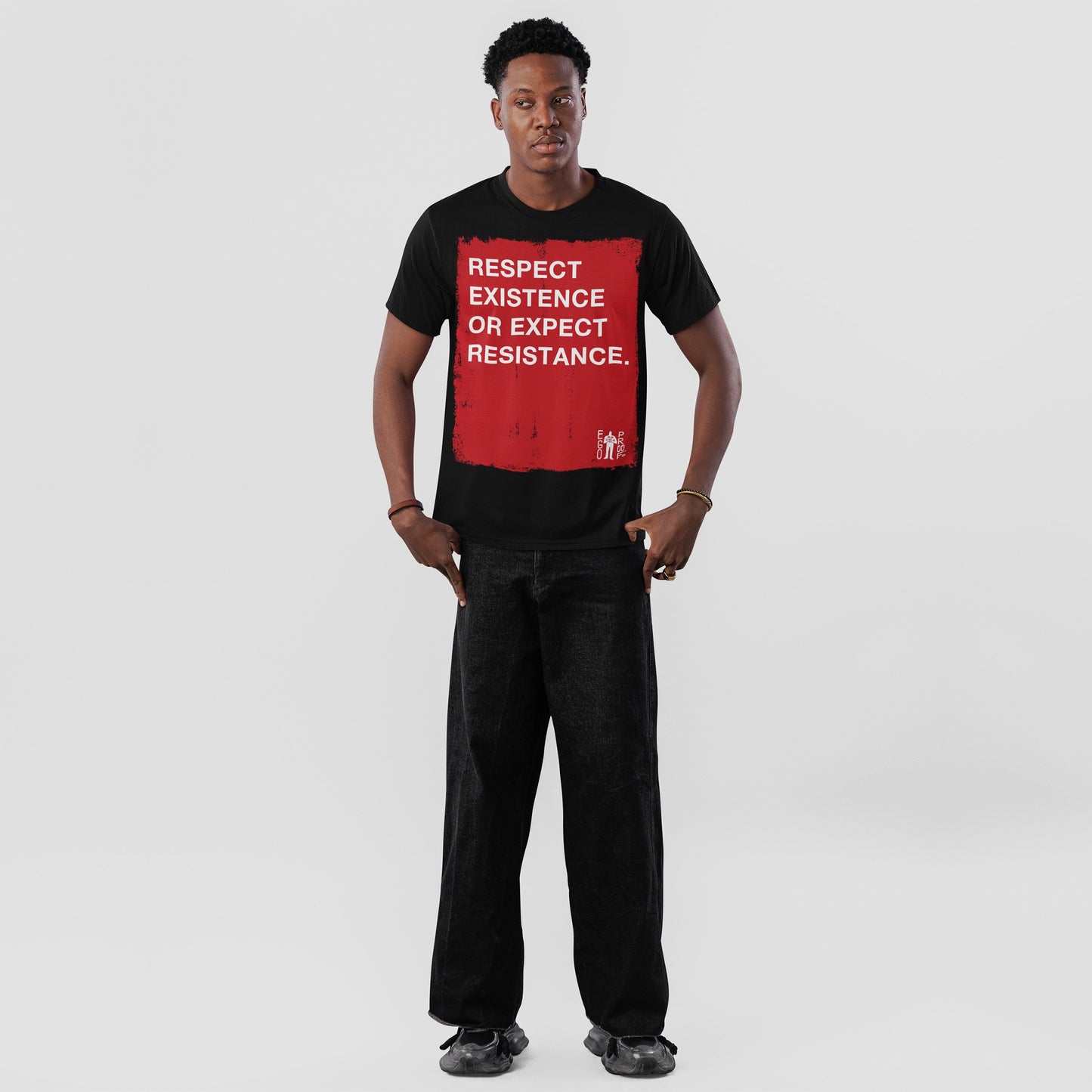 Respect Existence T-shirt: A young man models a bold black tee with a red square and white text, promoting resistance against oppression. Perfect for advocacy and everyday empowerment.