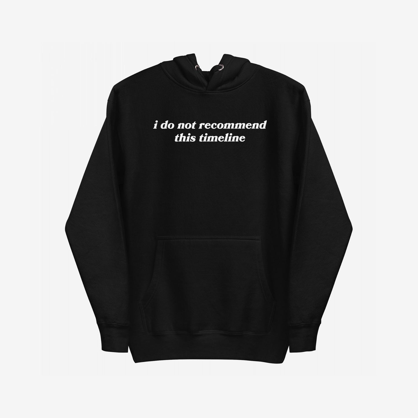 Timeline Hoodie EU: A black pullover with a kangaroo pocket, featuring the phrase i do not recommend this timeline in white serif lettering across the chest. Ideal for those feeling overwhelmed.