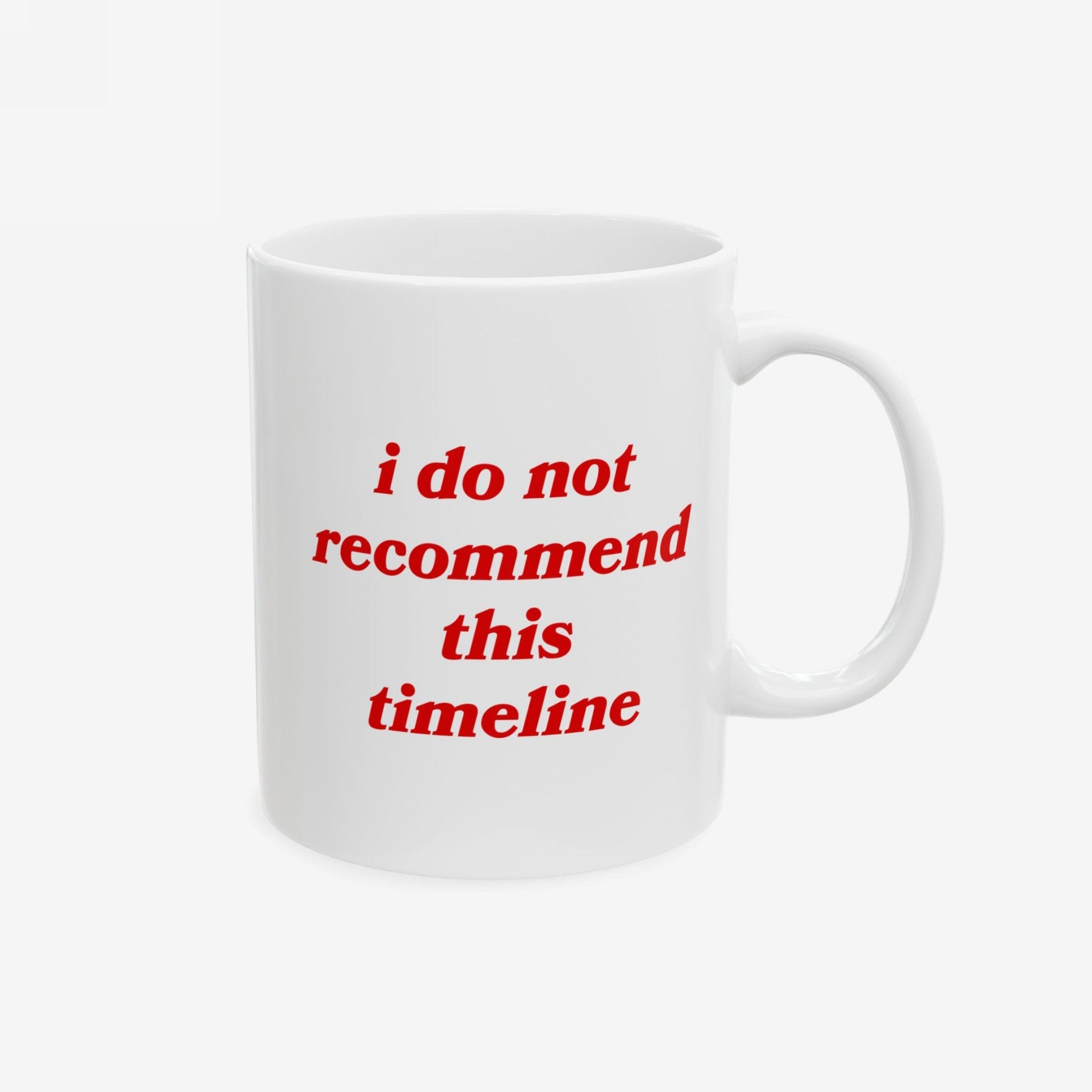 Timeline Mug displaying italic red text, i do not recommend this timeline, on a white ceramic surface. Crafted for those embracing sarcasm amid life's chaos, reflecting Egoproof's poignant messaging on mental health awareness.